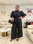Black puff-sleeve top and wide-leg pants with embroidered floral accents