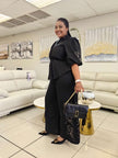 Black puff-sleeve top and wide-leg pants with embroidered floral linework