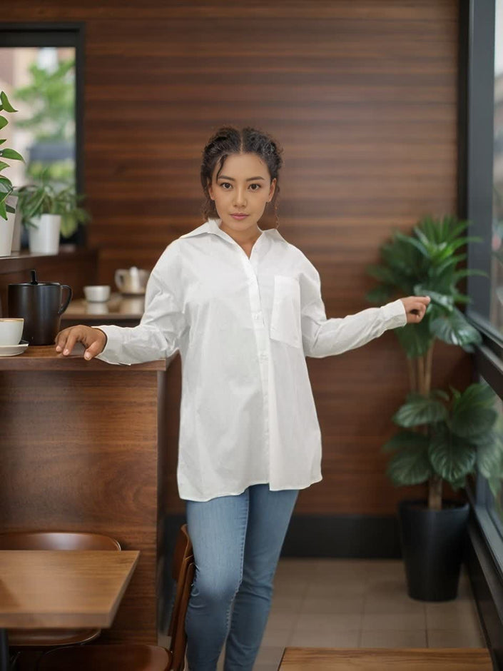 Relaxed fit white button-up shirt with point collar, long sleeves, and front buttons
