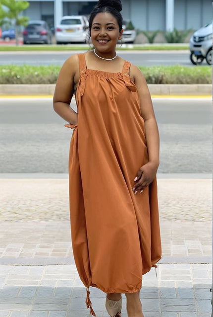 Brown utility maxi dress with smocked square neckline and adjustable drawstring waist