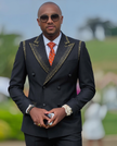 Black tuxedo suit jacket with gold embroidered peak lapels and double-breasted buttons