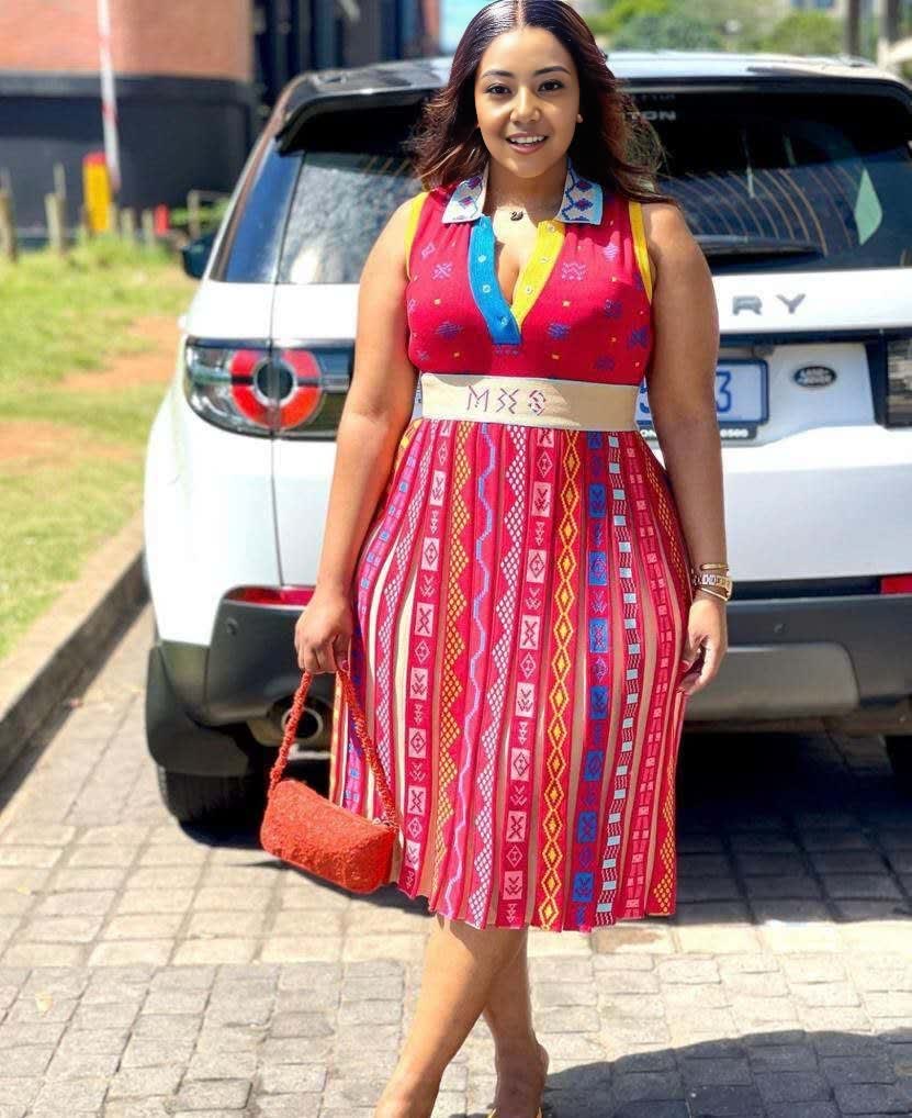 Embroidered sleeveless midi dress with red multicolor patterned bodice and skirt